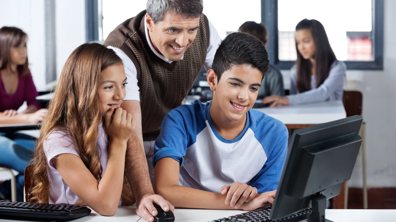 Students And Teacher In Front Of Computer