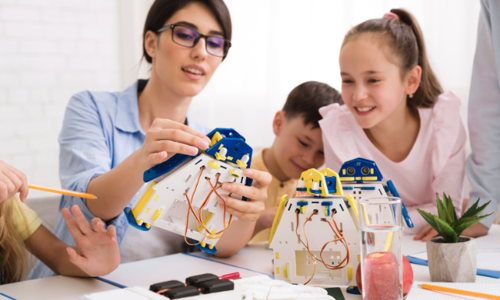Kids constructing robots with teacher