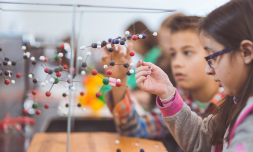 Group of elementary students doing STEM activities in a classroom