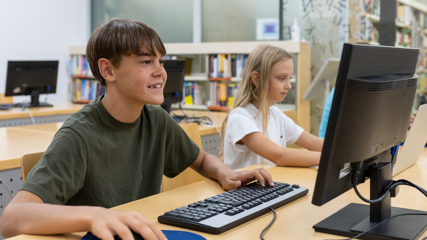 Students In Library On Computer