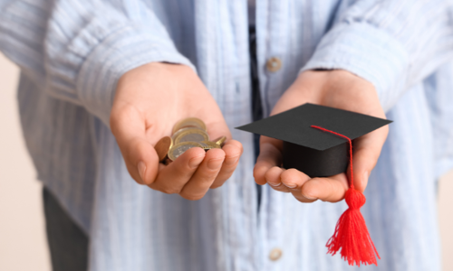 Woman holding money and graduation hat